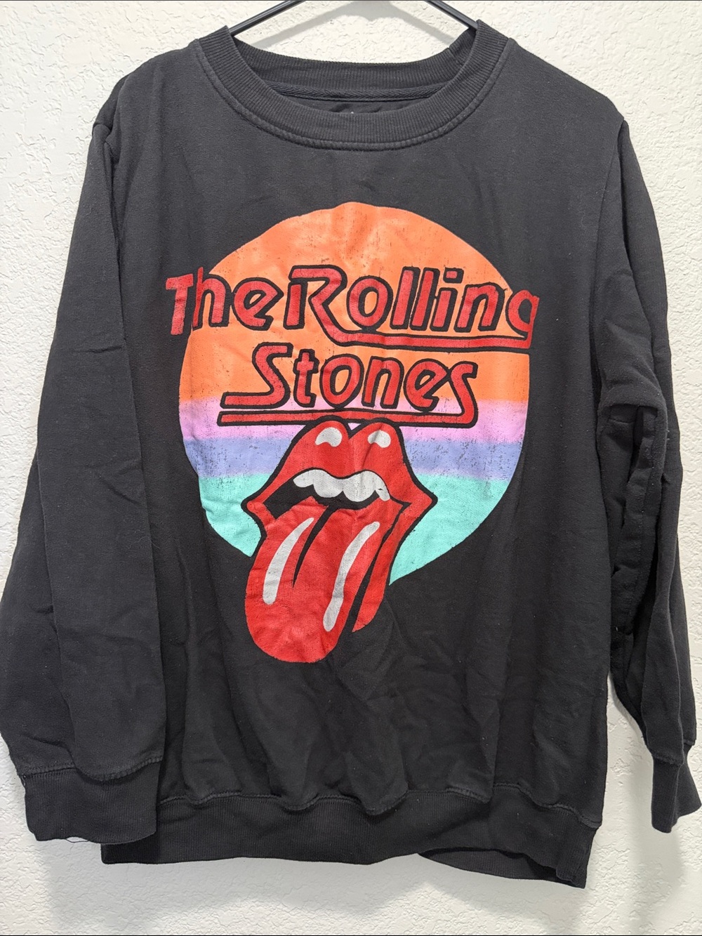 the Rolling Stones Black Sweatshirt with Red Tongue and Sunset Graphic